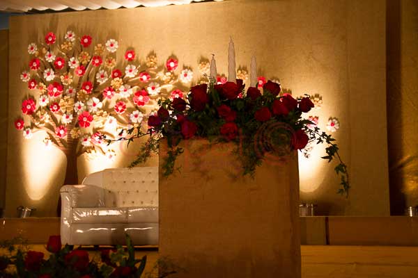 artificial flower stage decor with candle 